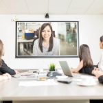 people doing online meeting in conference room.